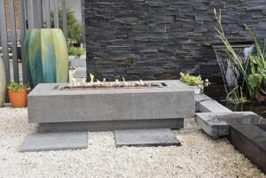 Elementi large rectangular propane fire pit table in light grey, includes canvas cover, lava rocks, and gas key valve, perfect for outdoor patios and backyard spaces.