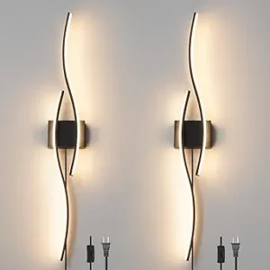 Set of two modern black plug-in wall sconces with dimmable LED lights, mounted in a living room setting for ambient lighting.
