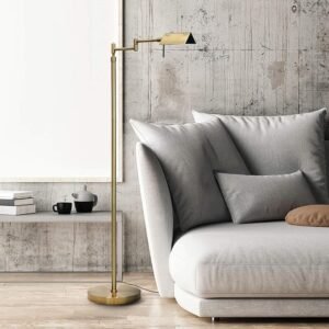 Brass adjustable pharmacy floor lamp beside a modern gray sectional sofa in a minimalist living room with layered lighting design.